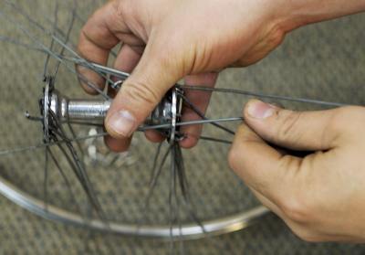 File:Removing-spokes-from-flange.jpg